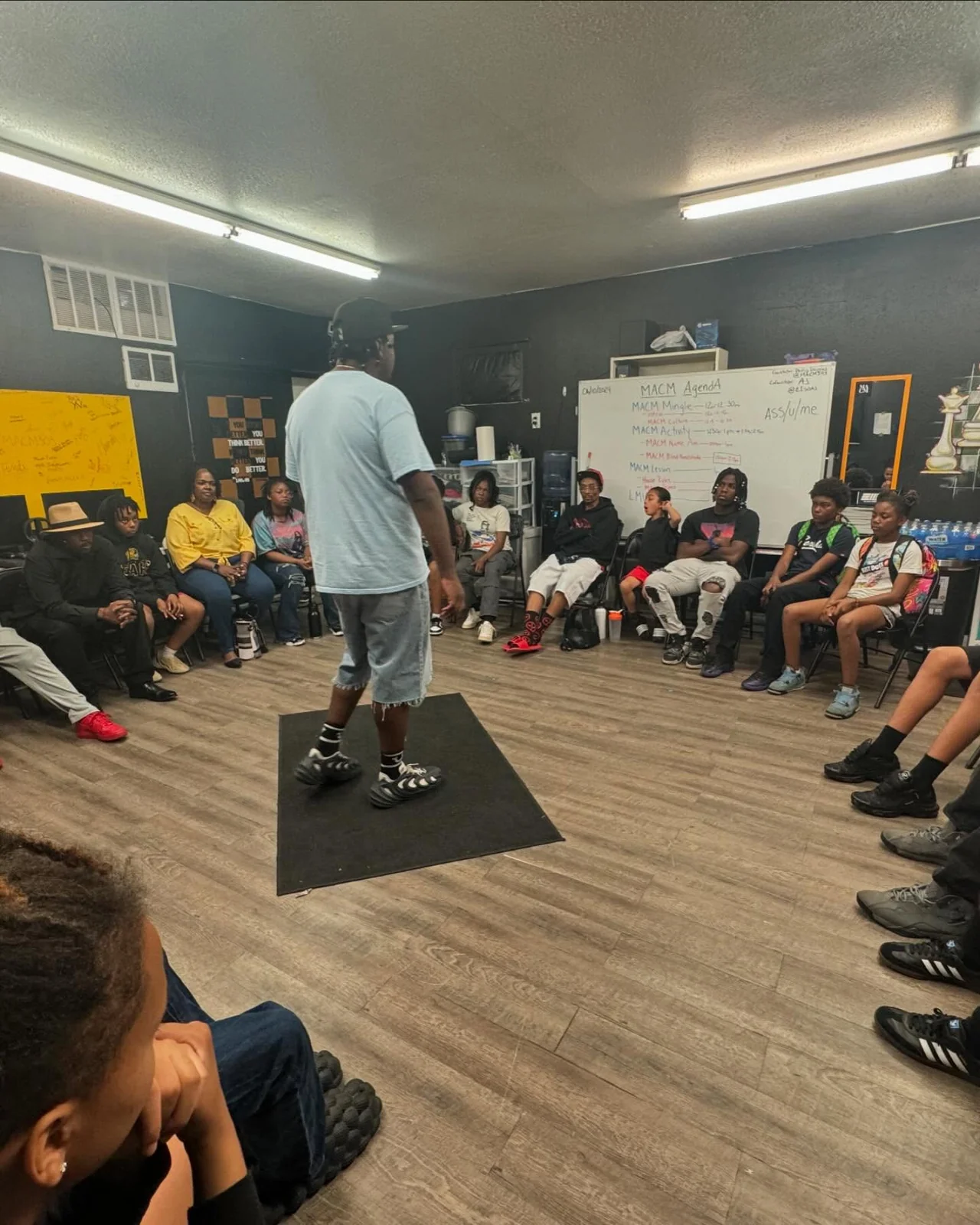 A group session with youth and a facilitator in a circle