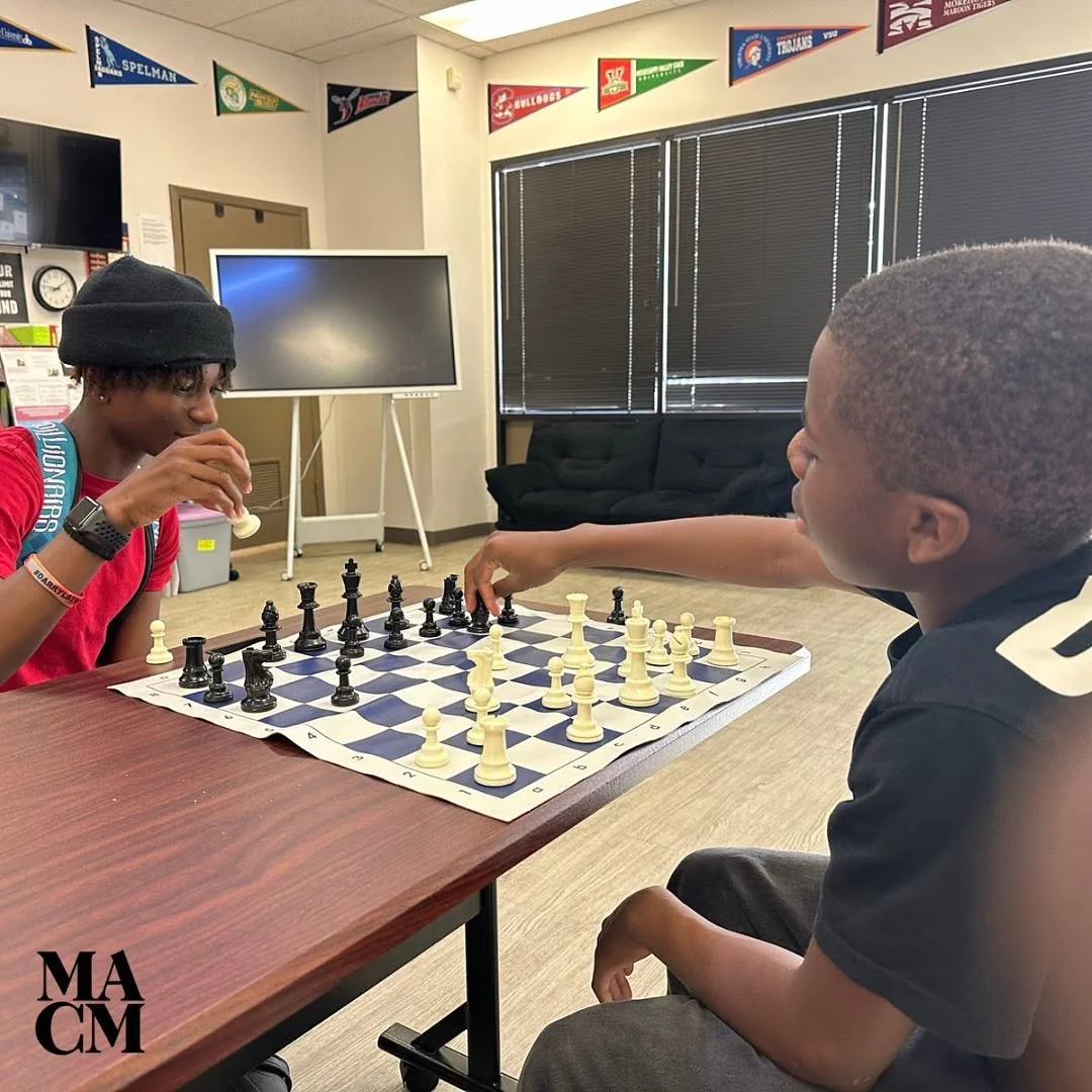 Two boys facing each other during a chess match